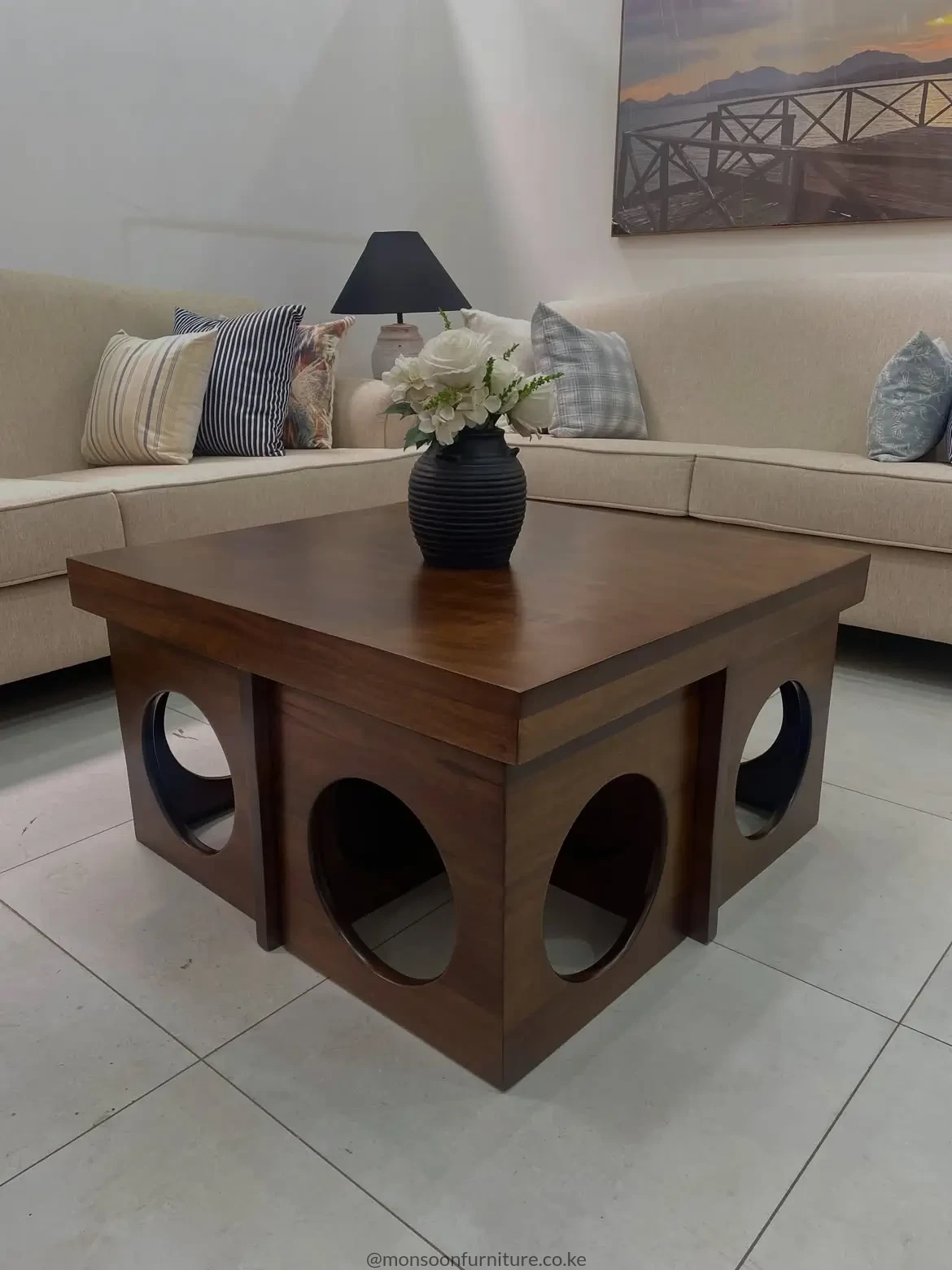 Walnut-look fluted coffee table with rounded corners, dark legs and enclosed body in a contemporary living room