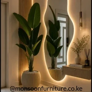 Wavy vertical wall mirror with warm perimeter lighting beside wood-tone slats and a floating console.