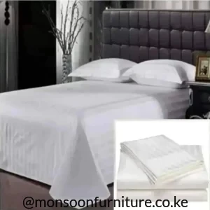 White striped duvet cover set on a bed with matching white pillowcases and bedding
