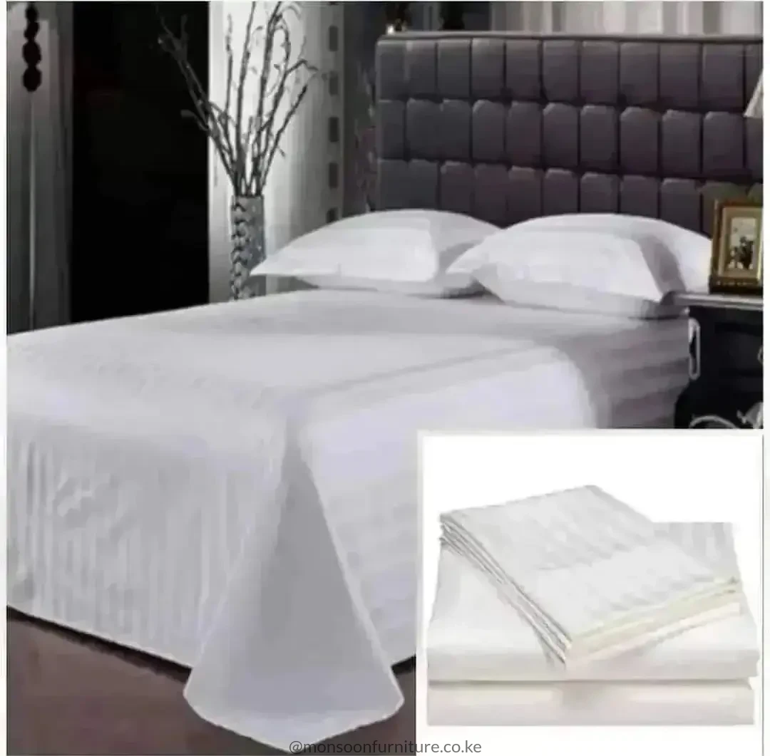 White striped duvet cover set on a bed with matching white pillowcases and bedding