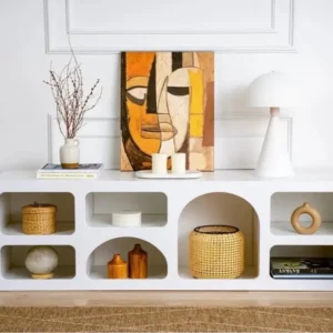 White arched display storage console with multiple open compartments for books and décor