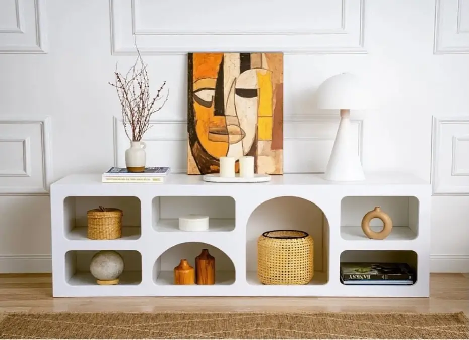 White arched display storage console with multiple open compartments for books and décor