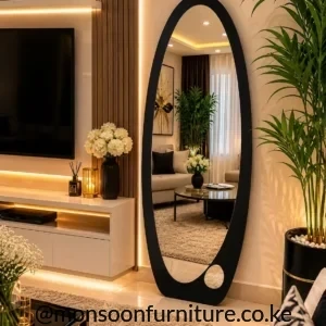 Tall black organic floor mirror with an asymmetric curved frame and small circular cut-out near the lower edge.