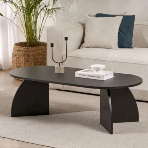Black sculptural oval centre table with curved supports in a neutral modern living room