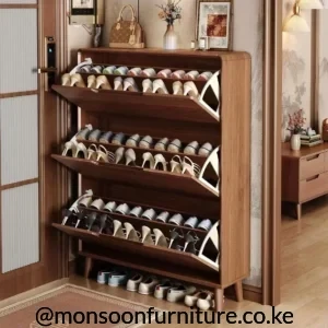 Brown shoe cabinet with three open tilt-out compartments, light side accents, raised legs and an open lower footwear shelf