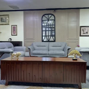 Brown 5ft TV console with raised geometric front panels displayed in a furnished living room