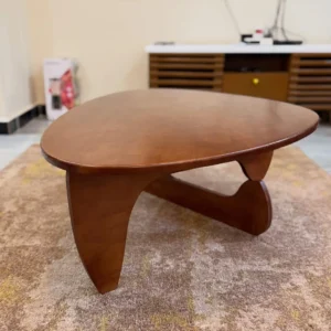 Brown organic coffee table with softly rounded triangular top and warm wood-look finish