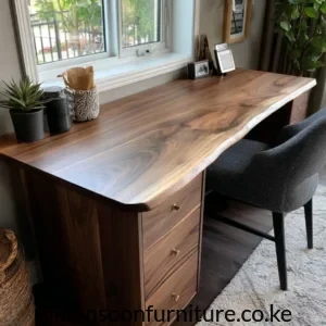 Calloway walnut desk with broad wood-grain top, three drawers and gold-tone knobs beside an upholstered chair