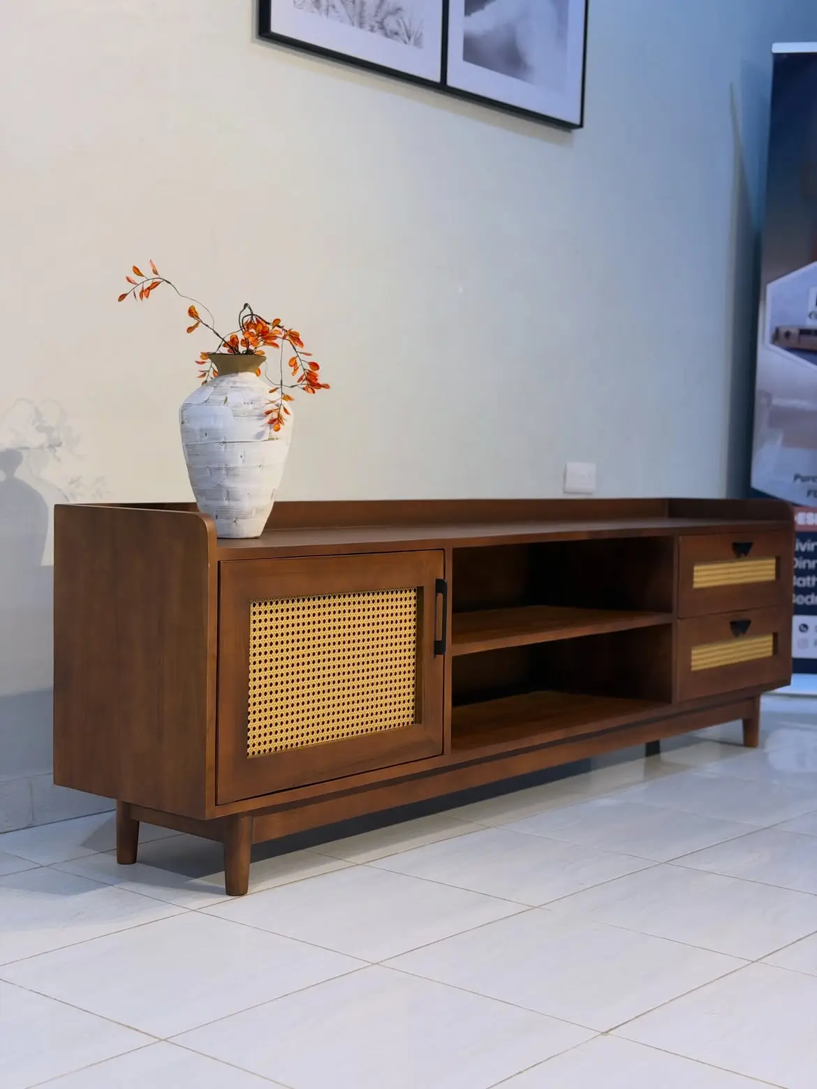 Brown media console with woven front panel, drawers and open shelving