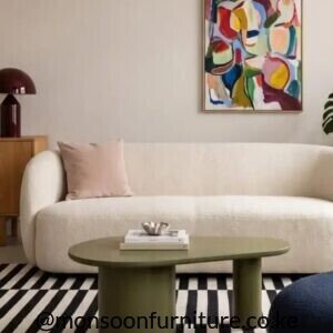Cream curved upholstered sofa with rounded arms and back in a modern living room