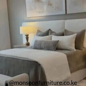 Cream upholstered 5×6 bed with wide padded headboard in a neutral modern bedroom