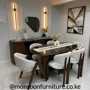 Dark brown oval dining table with six light grey upholstered chairs featuring rounded backs and sculptural supports.