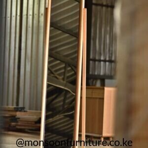 Tall freestanding dressing mirror with warm wood frame, two short front feet and a long rear support.