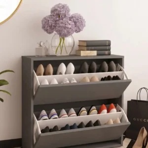 Grey tilt-out shoe cabinet with two open footwear storage compartments in an entryway