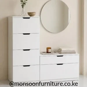 White stepped bedroom dresser with four tall drawers, two wide lower drawers and recessed dark pulls.