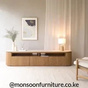 Liyanda natural TV console with rounded ends, fluted front and open media shelf in a neutral living room
