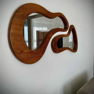 Mahogany frame sculptural wall mirror with an asymmetrical organic shape