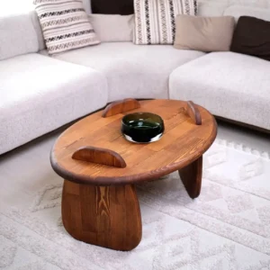 Mahogany round low coffee table with warm brown wood finish and three raised curved tabletop details