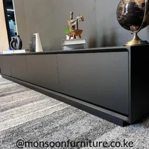 Matte black minimalist TV console with four clean-front cabinet doors in a contemporary living room