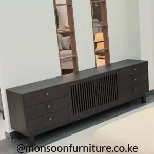 Dark MDF TV unit with six drawers and a vertical fluted centre panel in a living room