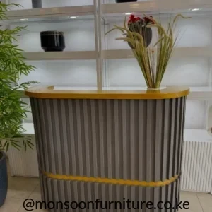 Mustard reception desk with curved fluted front, rounded counter and smooth angled side panel