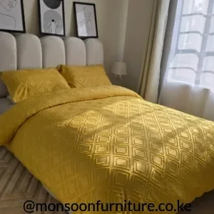 Mustard geometric duvet cover set with matching textured pillow cases on a neutral upholstered bed
