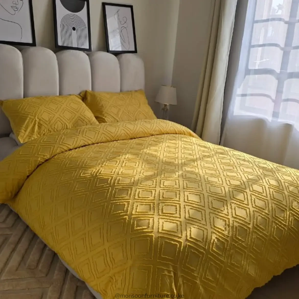 Mustard geometric duvet cover set with matching textured pillow cases on a neutral upholstered bed