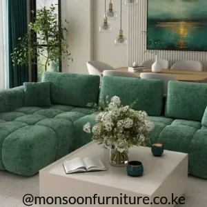 Olive green sofa bed with broad left chaise, rounded padded arms and loose back cushions in a modern living room