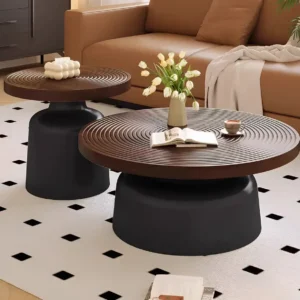 Two round nesting coffee tables with dark brown concentric rippled tops and black pedestal-style bases