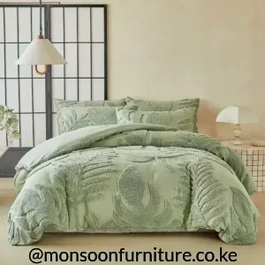Sage green duvet cover with raised botanical tufting and matching textured pillowcases on a made-up bed
