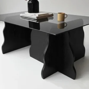 Sculptural glass top coffee table with four curved natural wood-look supports