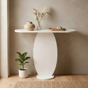 Sculptural white hallway console with rounded top and curved pedestal base against a neutral wall