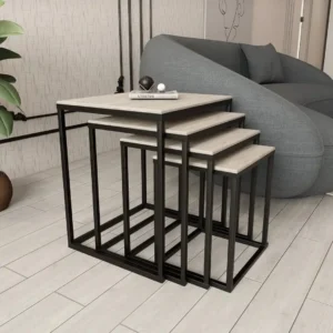 Four nesting sofa tables with light wood-look rectangular tops and slim black frames in a living room