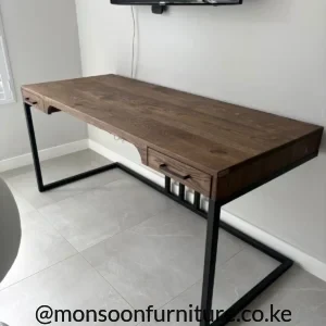 Solid oak desk with two drawers, natural brown wood grain and open black frame legs in a home office