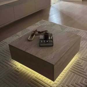 Square neutral coffee table with warm under-table lighting on a textured living-room rug