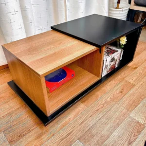 Two-tone wood-look coffee table with black raised top and open storage compartments