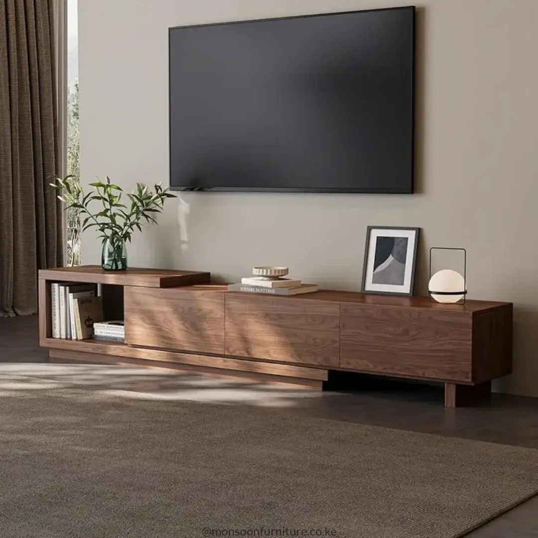 Warm brown low TV console with raised open display shelf and long closed storage beneath a wall-mounted television
