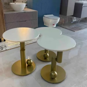 Three white round side tables with gold-tone pedestal bases displayed together