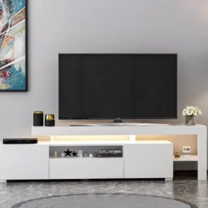 White entertainment unit with raised TV surface, enclosed lower storage, open display niches and illuminated recessed sections.