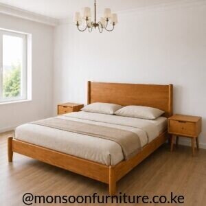 Wood-finish panel bed with broad headboard, low footboard, rounded posts and warm brown grain in a bright bedroom.