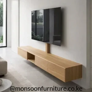 Light wood-tone floating TV console with flush storage and an open cubby beneath a wall-mounted television.