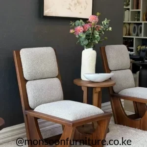 Wood-tone accent chair with light textured seat, two separate back cushions and curved open side detail.