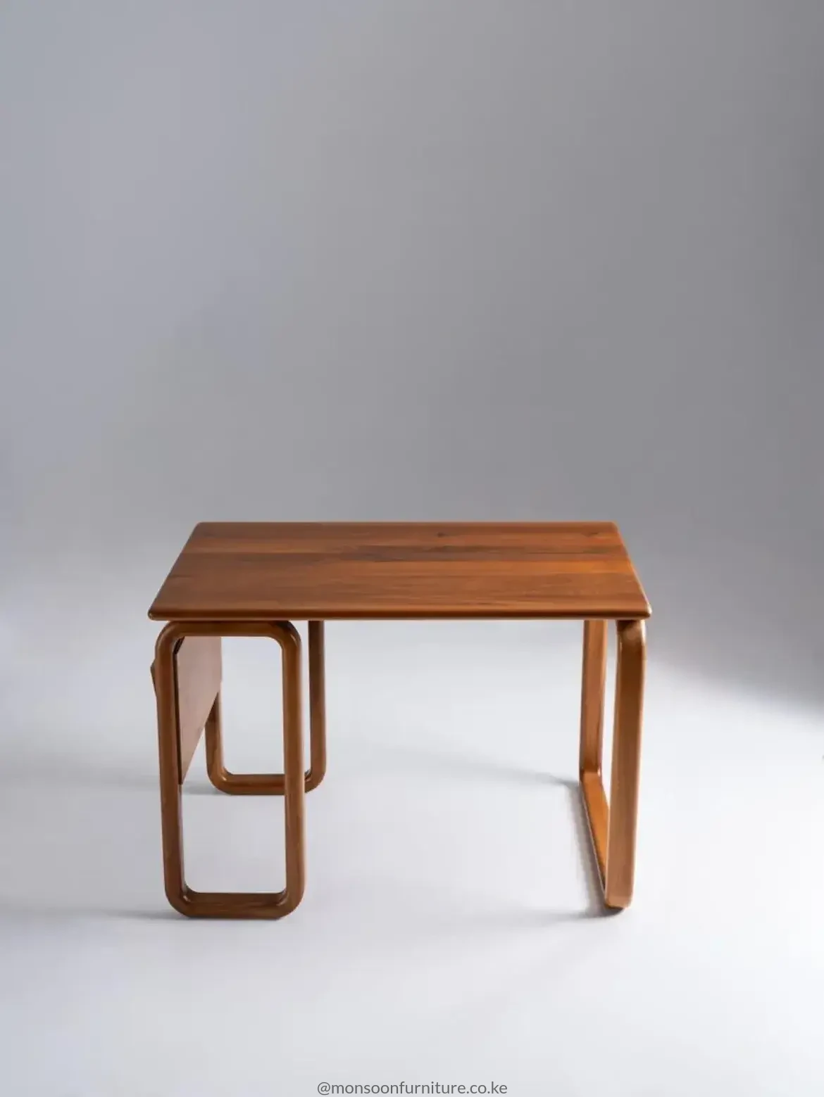 Wooden home office desk in warm brown finish with rectangular top and asymmetric open-frame wooden base