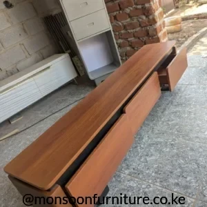 Wooden TV cabinet with drawers in warm brown wood-look finish and dark contrasting storage sections