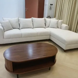 Cream L-shaped sofa with extended chaise and rounded arms