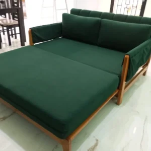 Dark green sofa bed opened into a 5x6 sleeping surface with exposed wood frame