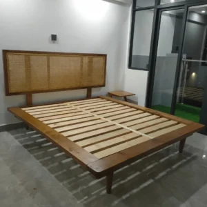 Monsoon Alderbridge 5×6 wooden bed with wide woven headboard and exposed slatted mattress base.