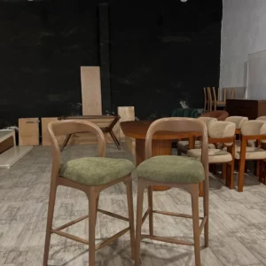 Alderfield wooden bar stool with green padded seat and curved back