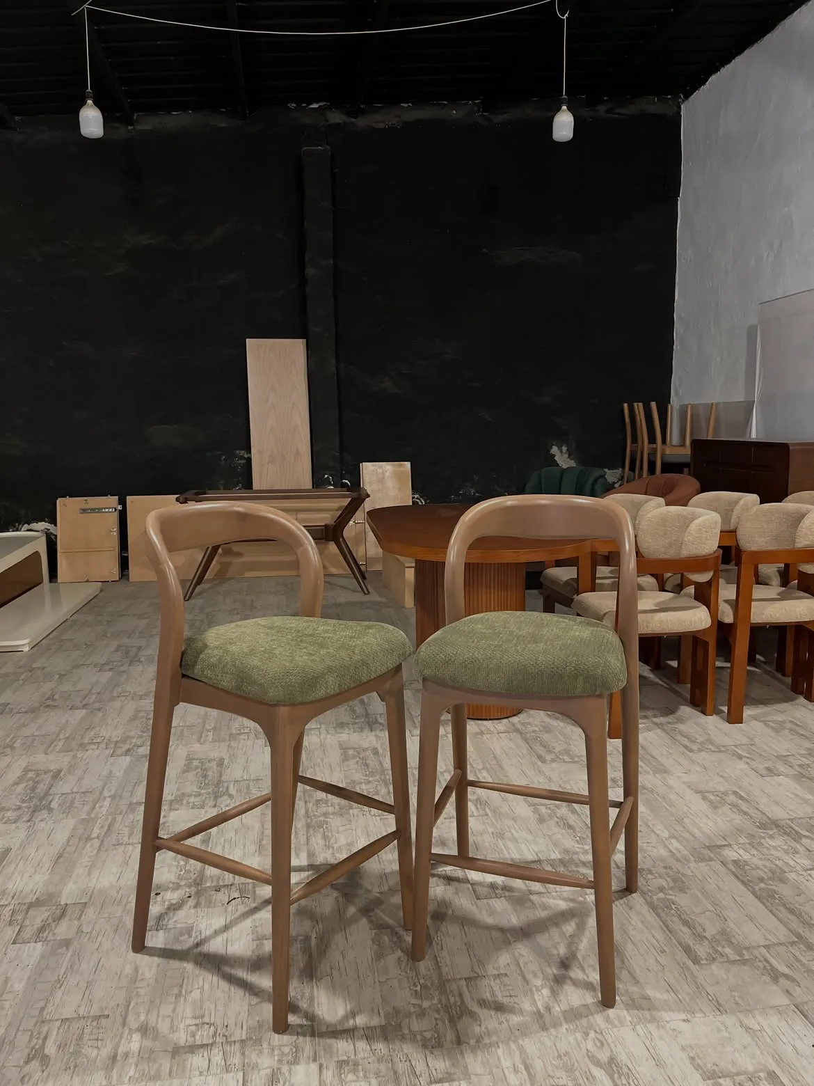 Alderfield wooden bar stool with green padded seat and curved back