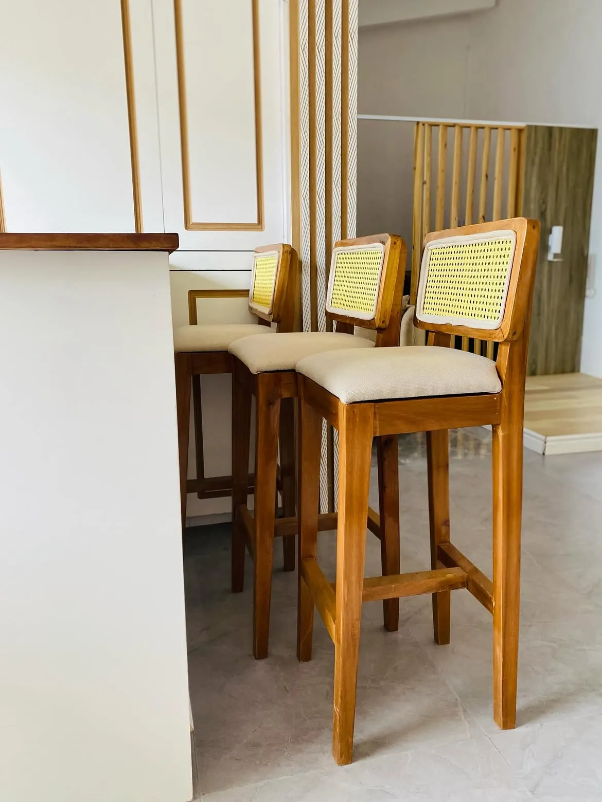 Braemar rattan bar stool with cream upholstered seat and woven back